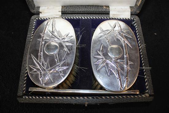 Cased pair of silver Chinese brushes.